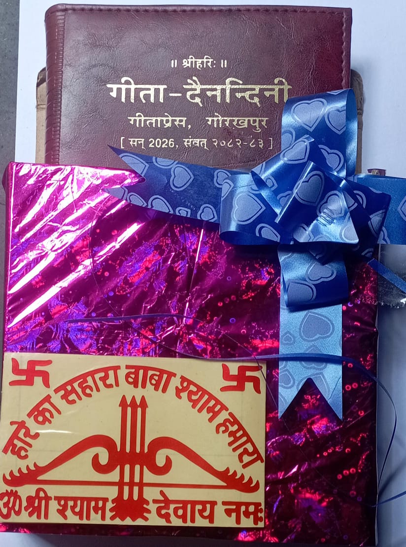 Gift wrapped in pink paper with a blue bow, placed on a surface.