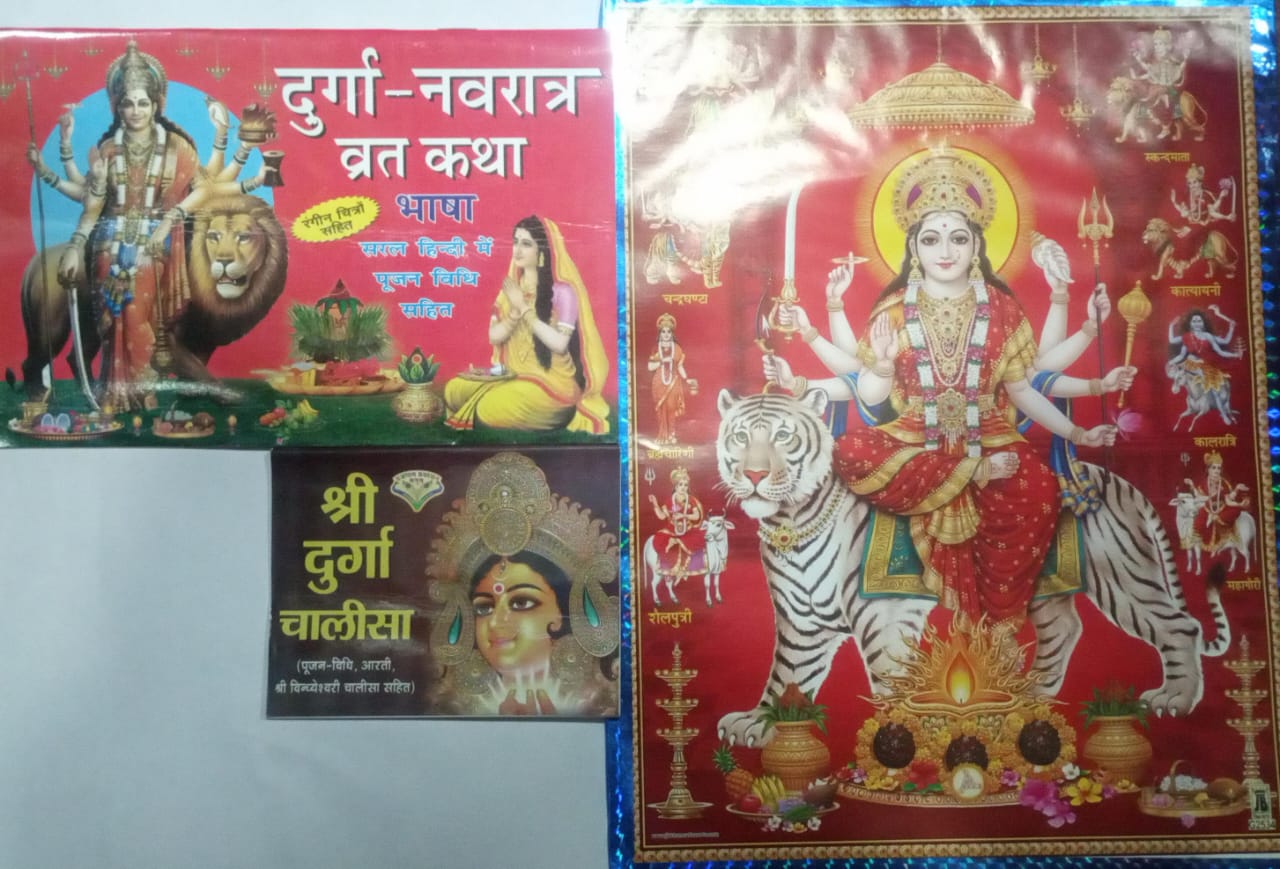 Set of books with illustrations of deities on a reflective surface