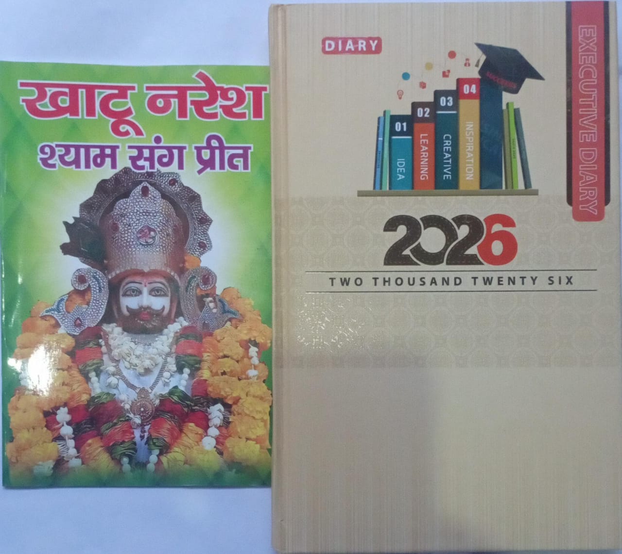 Two books, one with a colorful cover featuring a deity and the other with '2026' on a white background