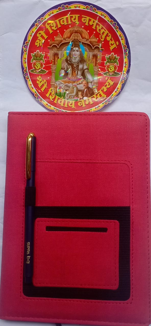 Red notebook with pen holder and decorative cover on a white background