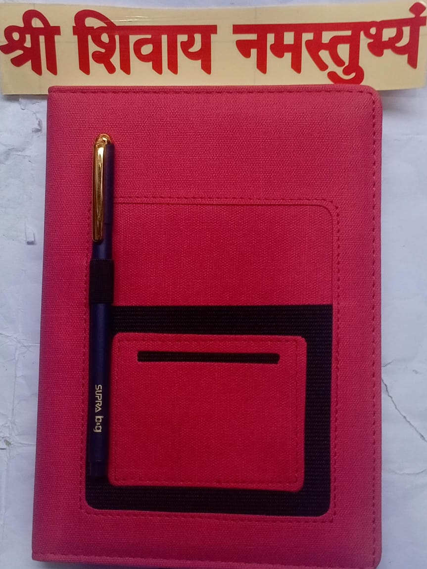 Red wallet with a pen and 'Sri Shivaya Namastu' text in the background